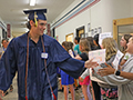  Kenmore East senior high fives younger students through halls of Franklin Middle School.